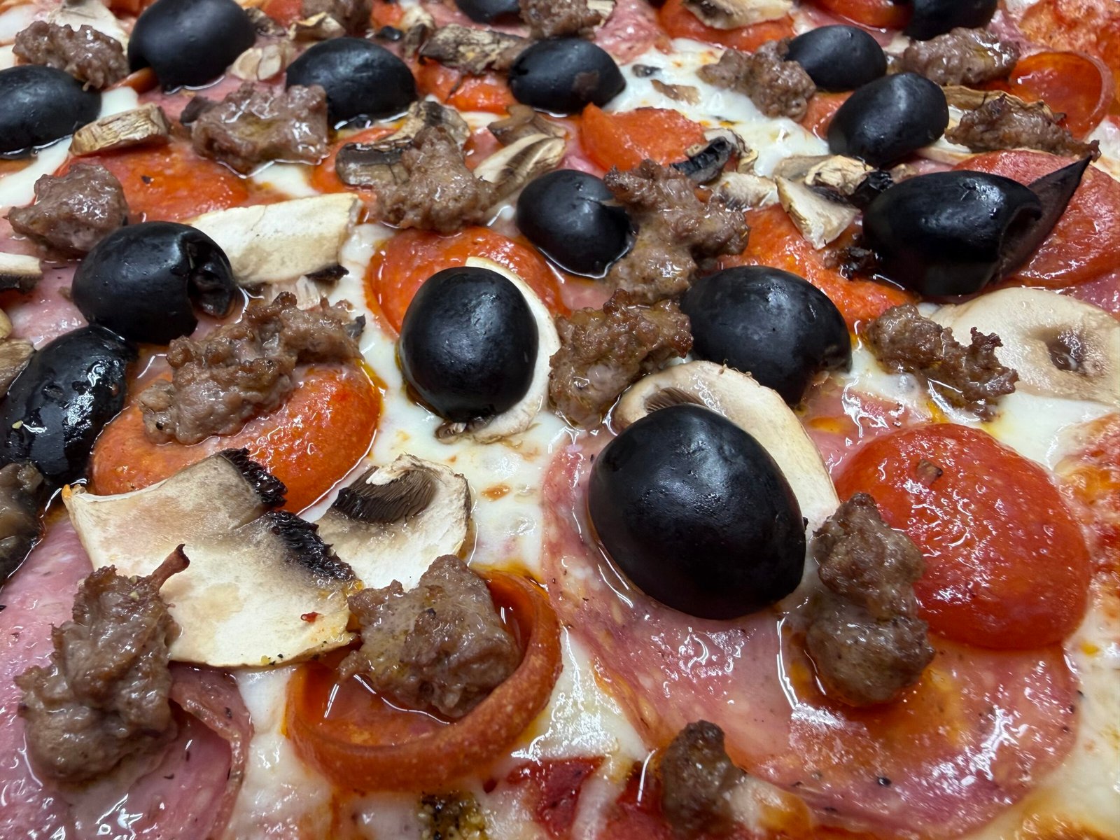 The Legend pizza with salami, pepperoni, mushrooms, black olives, and seasoned ground beef